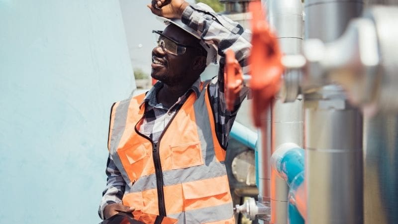 a happy oilfield worker with a mobile device