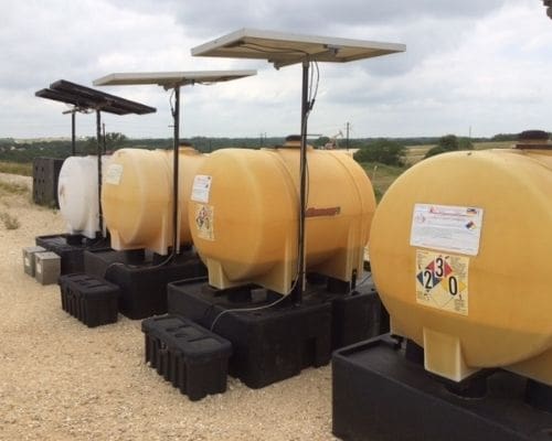 a row of chemical injection tanks at a pipeline facility